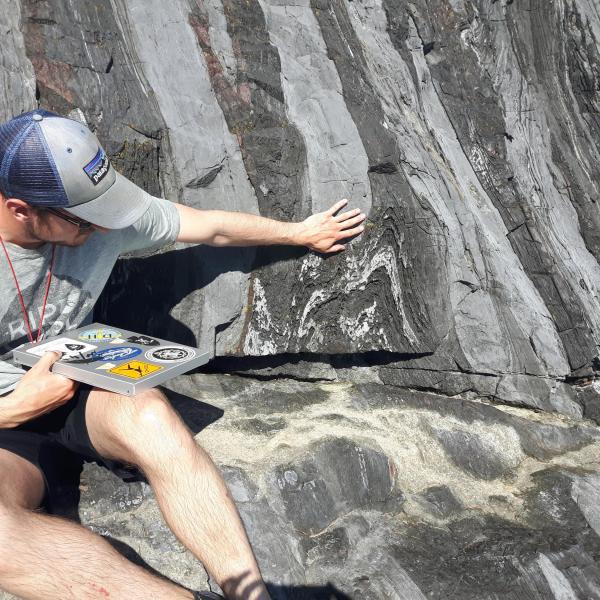 Student demonstrating cool folds in limestone on Quadra Island