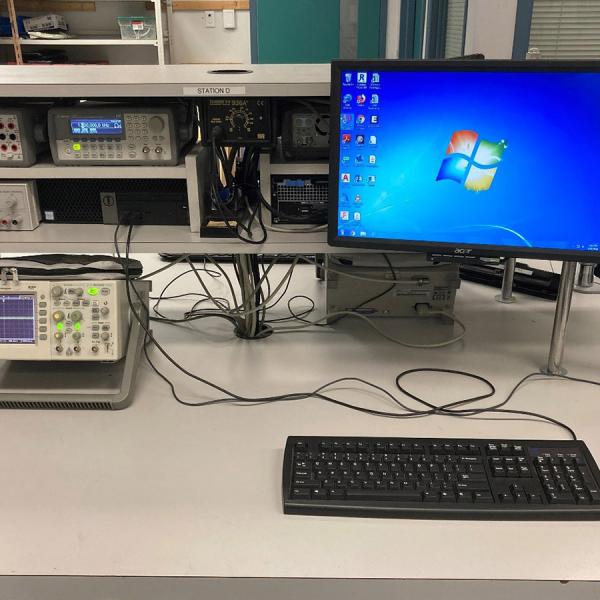 Close-up of student Workbench including  computer, function generator, multimeter, power supply,  and oscilloscope.